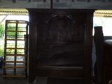 a wooden bed in the middle of a room with a ladder