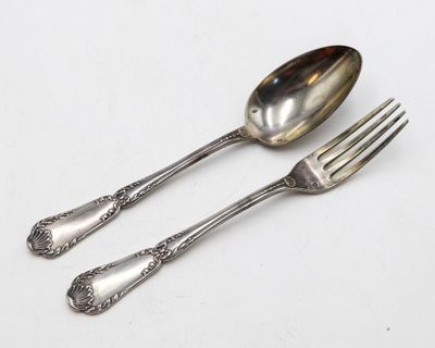 deux cuillères et une fourchette sur une table blanche