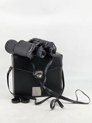 an old camera with a black case and a pair of binoculars on a white background