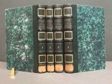 three books are stacked on top of each other on a table