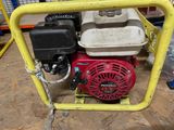 a small red and black engine in a yellow frame