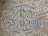 a blue stamp on the concrete of a building