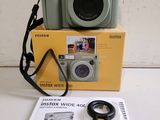 a camera sitting on top of a box next to a book