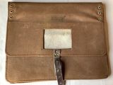 a brown leather case with a knife inside of it