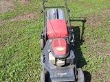 a lawn mower that is sitting in the grass