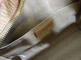 the inside of a purse with a hand holding it