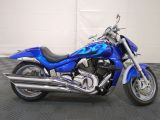 a picture of a blue motorcycle parked in a garage