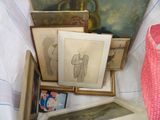 a lot of pictures and paintings on a bed