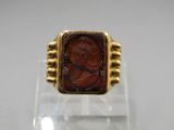 an image of a gold ring with a red stone in the center