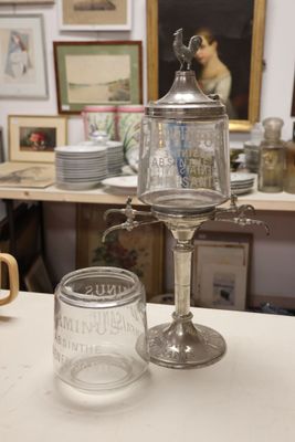 a glass jar sitting on top of a table next to a glass cup