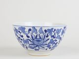blue and white bowl with a flower design on the side