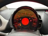steering wheel of a car with a speedometer and a red light