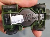 a hand holding a toy car with a tag on it