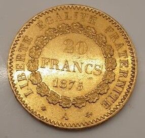 une pièce d'or sur laquelle est inscrit le mot « France »
