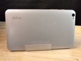 the back of a white tablet computer sitting on top of a wooden table