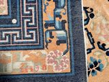 a cat that is sitting on a rug on the floor