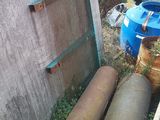 a pile of pipes and other items in the yard