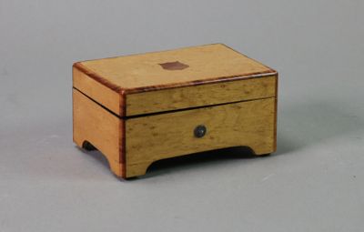 a small wooden box with a drawer on top of it