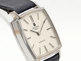 a silver watch with a black strap on a white background