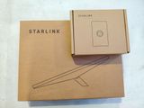 the box is open on a white surface with a starlink logo on it