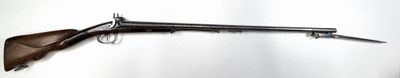 rifle mounted on a wall in a room with a white wall