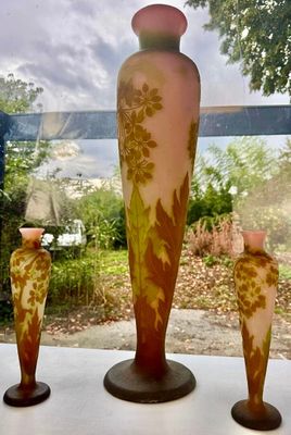 three vases sitting on a window sill in front of a window
