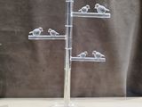 a glass display with birds on it on a table