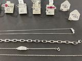 a group of silver necklaces and bracelets on a table