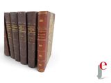 several old books are stacked on top of each other on a white surface