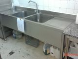 a kitchen with a sink and a refrigerator in it