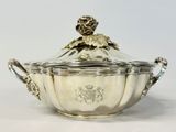 an antique silverplated sugar dish with a lion on the lid