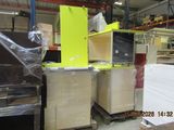 a lot of furniture in a warehouse with a lot of boxes