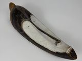 a banana shaped object on a white surface