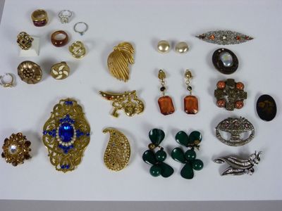 many different types of jewelry on a white surface