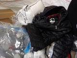 a pile of clothing and other items on the floor