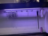 a purple light that is on above a sink
