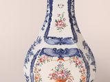a blue and white vase with a floral design on it