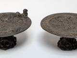 two metal trays that are sitting on a table