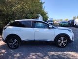 a white suv parked in a parking lot next to trees