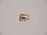 a close up of a gold ring with a diamond on it