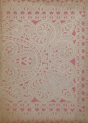 a white doily with pink and white designs on it