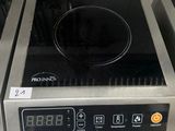 a black and silver stove top with a digital clock on it