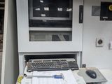 a desk with a computer and a printer on it