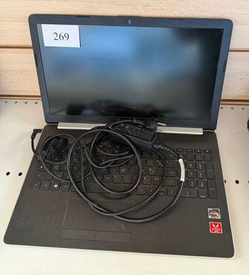 a laptop computer sitting on top of a desk with a charger