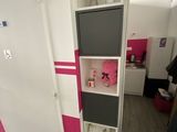 a tall cabinet in the corner of a small room