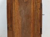 an old wooden cabinet with a door on the top of it