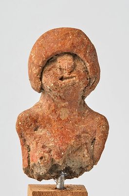 statue of a woman with a hat on top of a wooden base