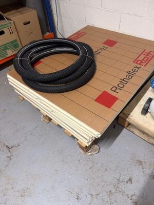 a pile of boxes and a hose on the floor