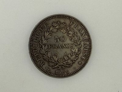 a close up of a coin on a table with a white background