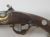 a close up of a gun on a white surface with a white background